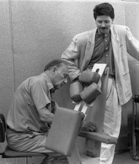 [Jim Everett and David Palmer tinkering with the massage chair]